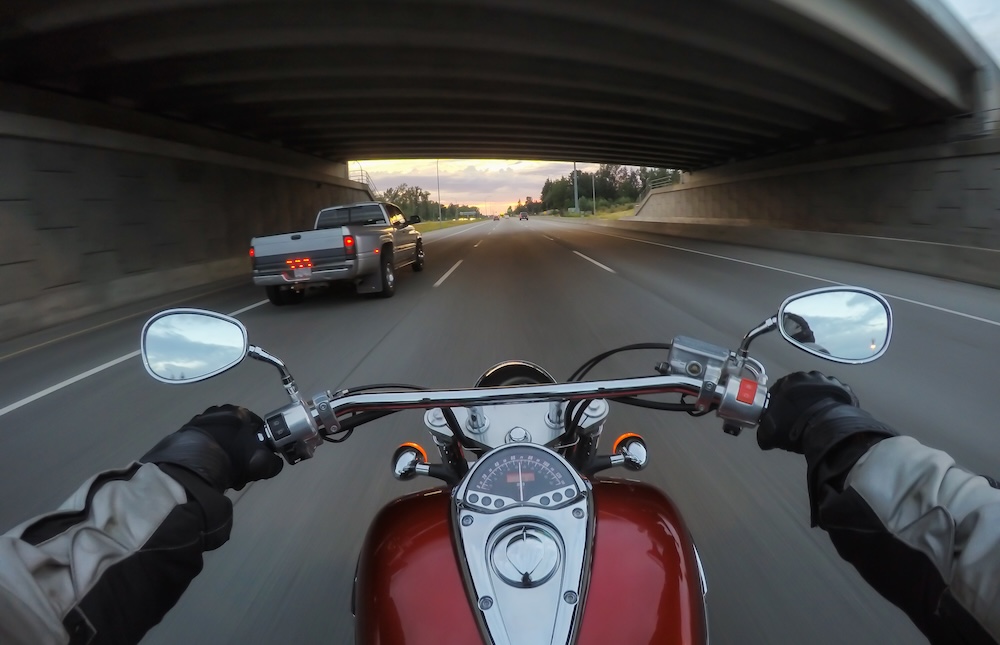 Riding a motorcycle during a vibrant sunset.