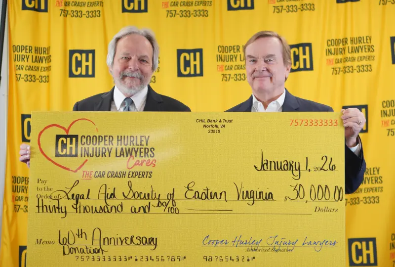 Cooper Hurley Injury Lawyers holding $30,000 donation check for Legal Aid Society of Eastern Virginia