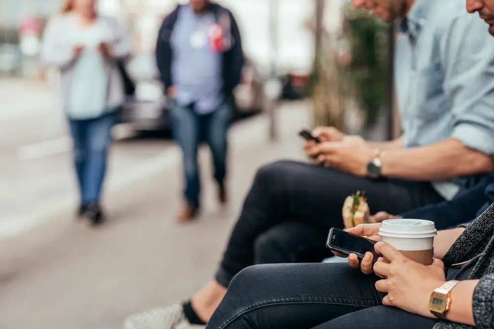 People sitting next to street waiting for uber