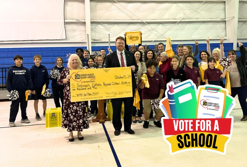 Previous vote for a school winners holding a giant check